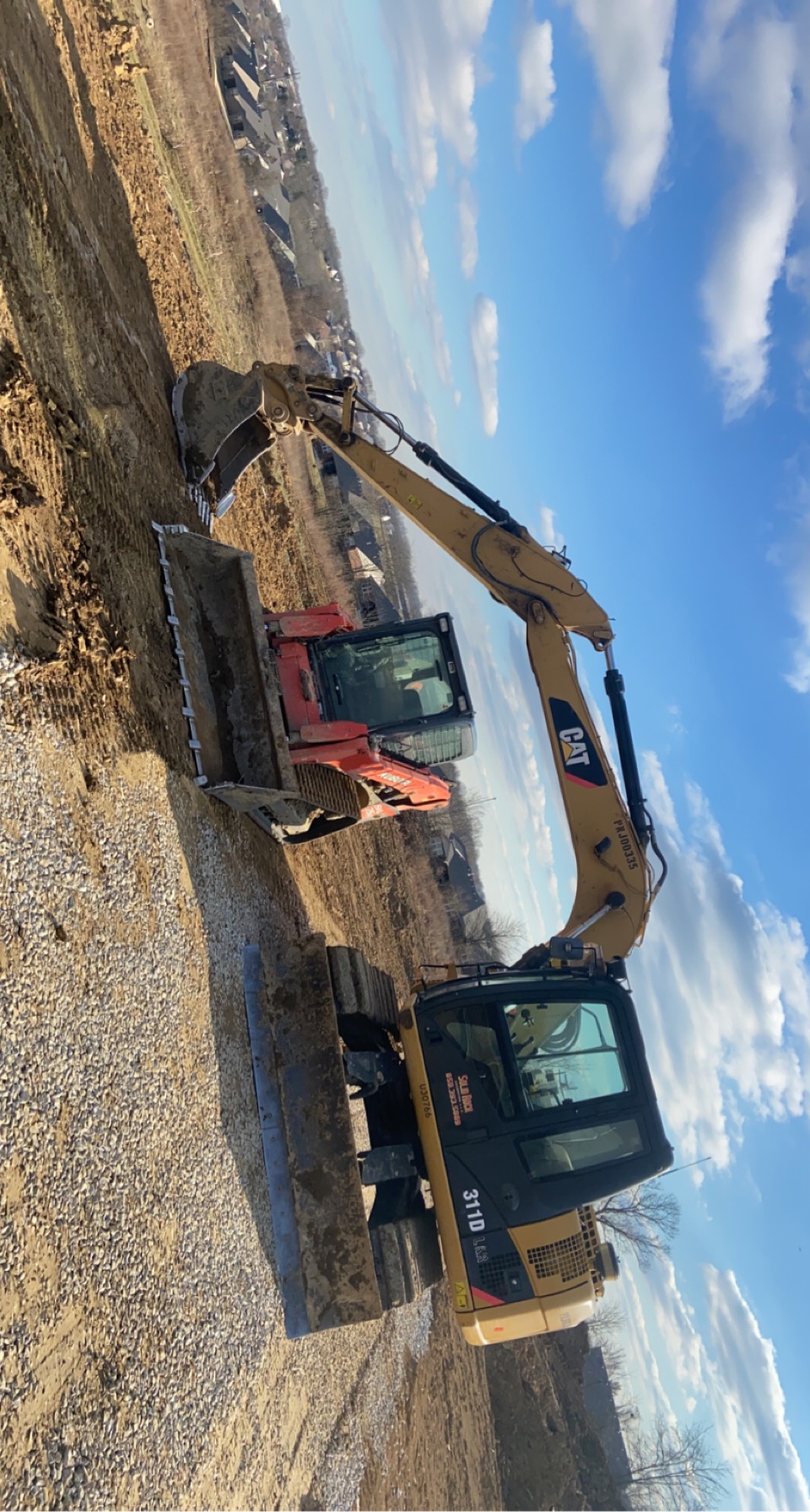 Solid Rock Excavating CAT 311D excavator and track loader on a site-prep job